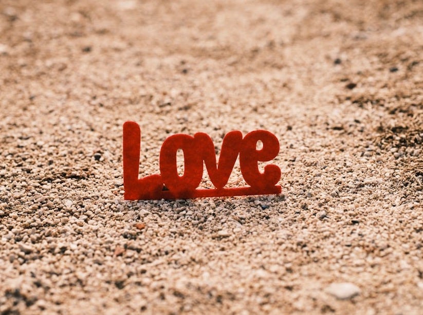 the word love spelled out in the sand the word love spelled out in the sand
