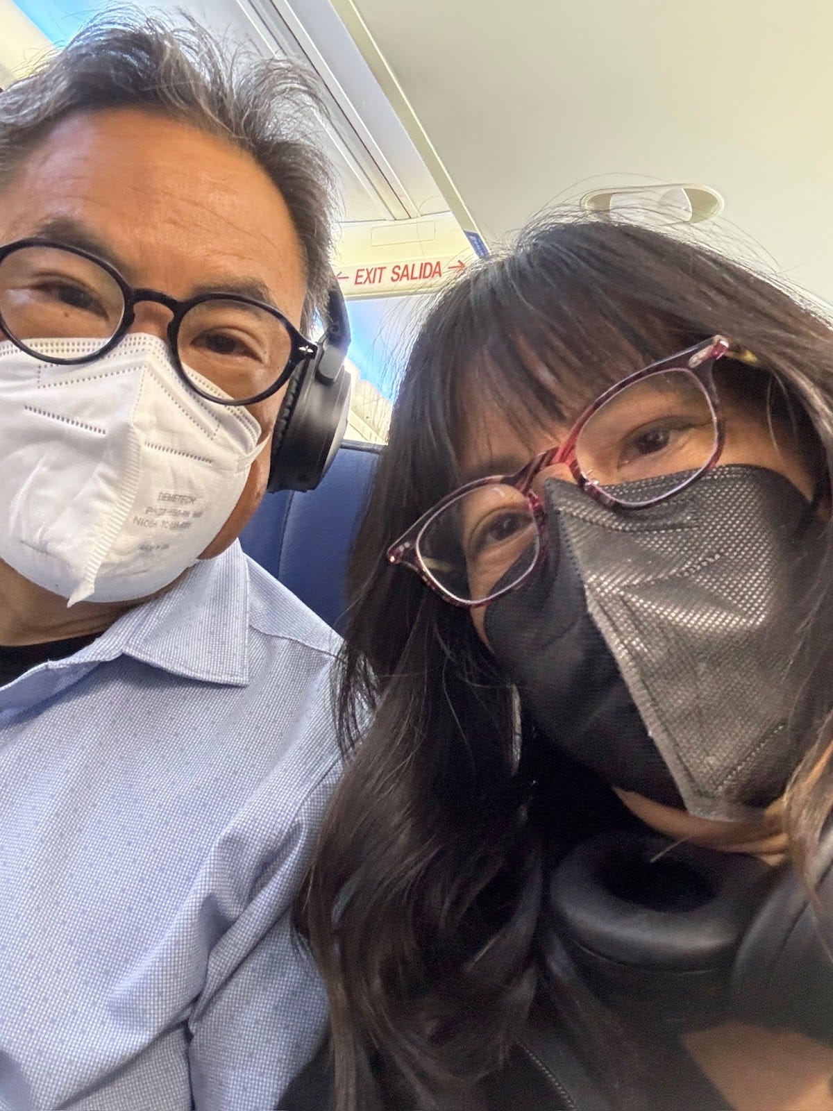 Selfie of Stephen and Marsha with N95 marks on United airplane Selfie of Stephen and Marsha with N95 marks on United airplane