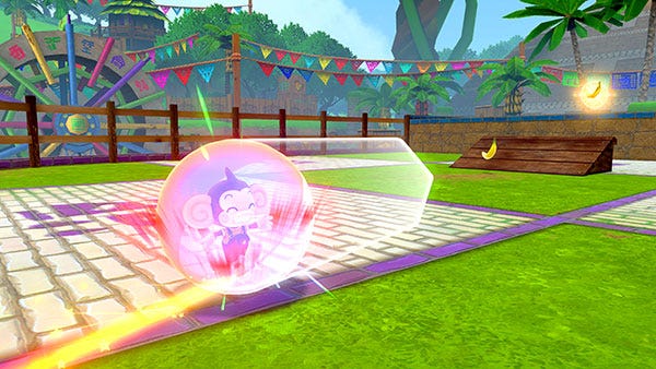 A monkey in a plastic ball preparing to laucnh towards a wooden ramp.