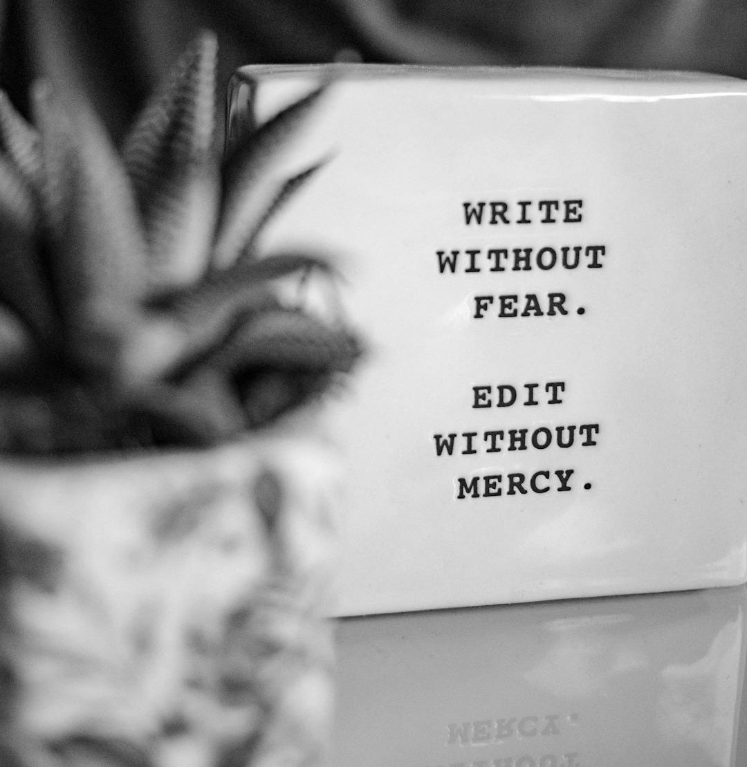 a white box with writing on it next to a plant