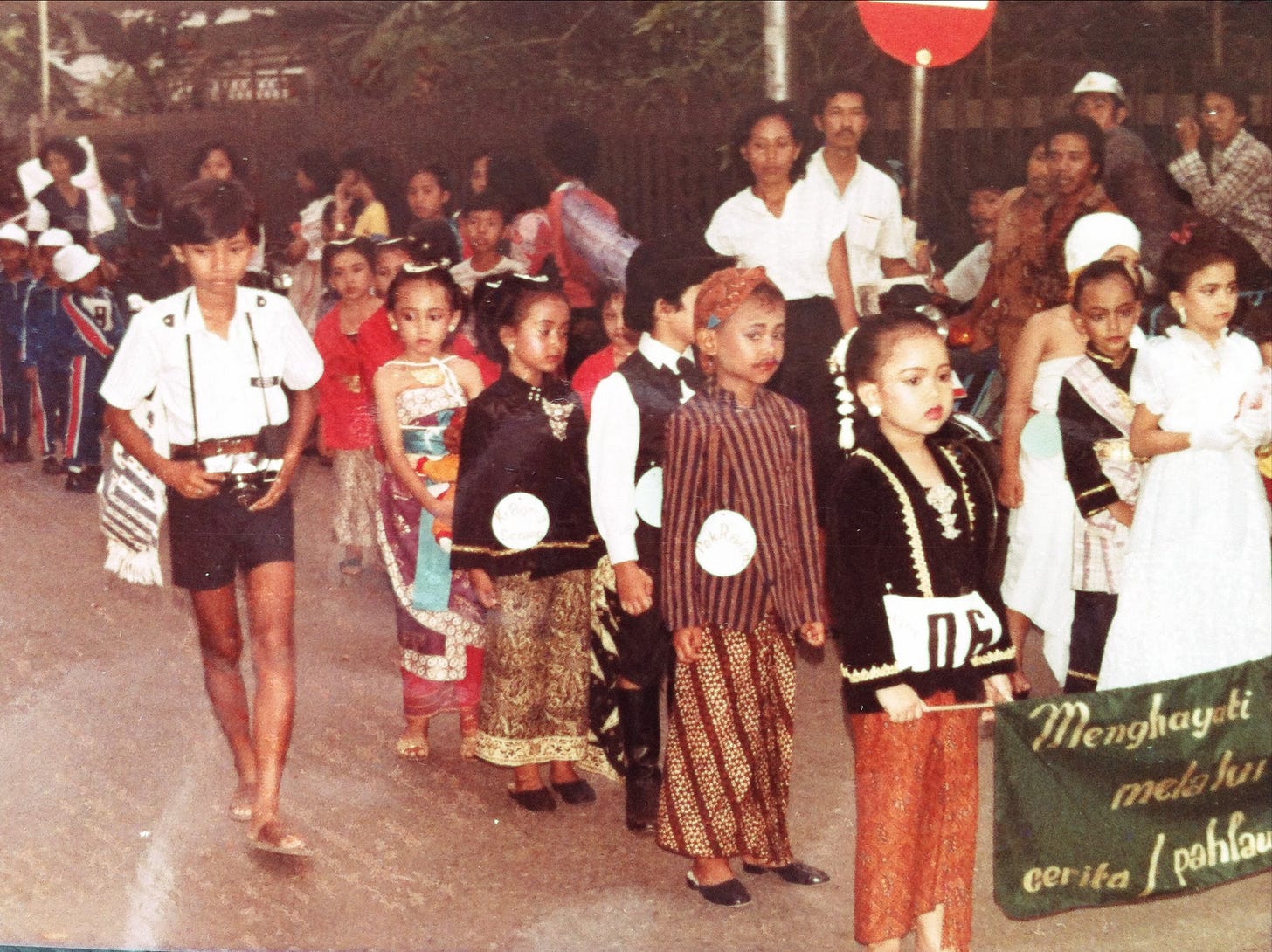 A photo of me carrying my dad's manual SLR, walking along this parade. Such a historical moment, I'm glad my parent had this preserved somehow.