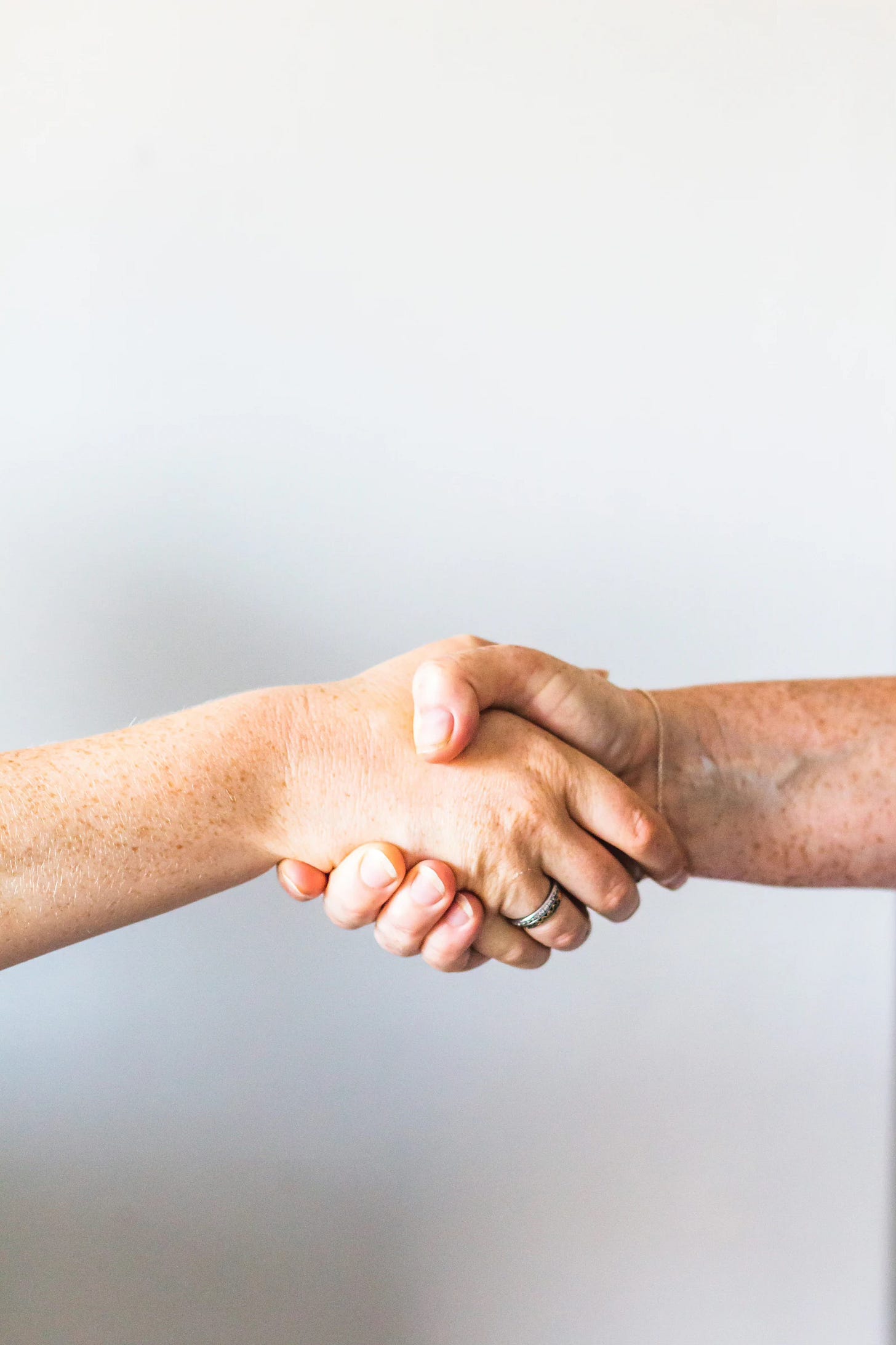 two people shaking/holding hands