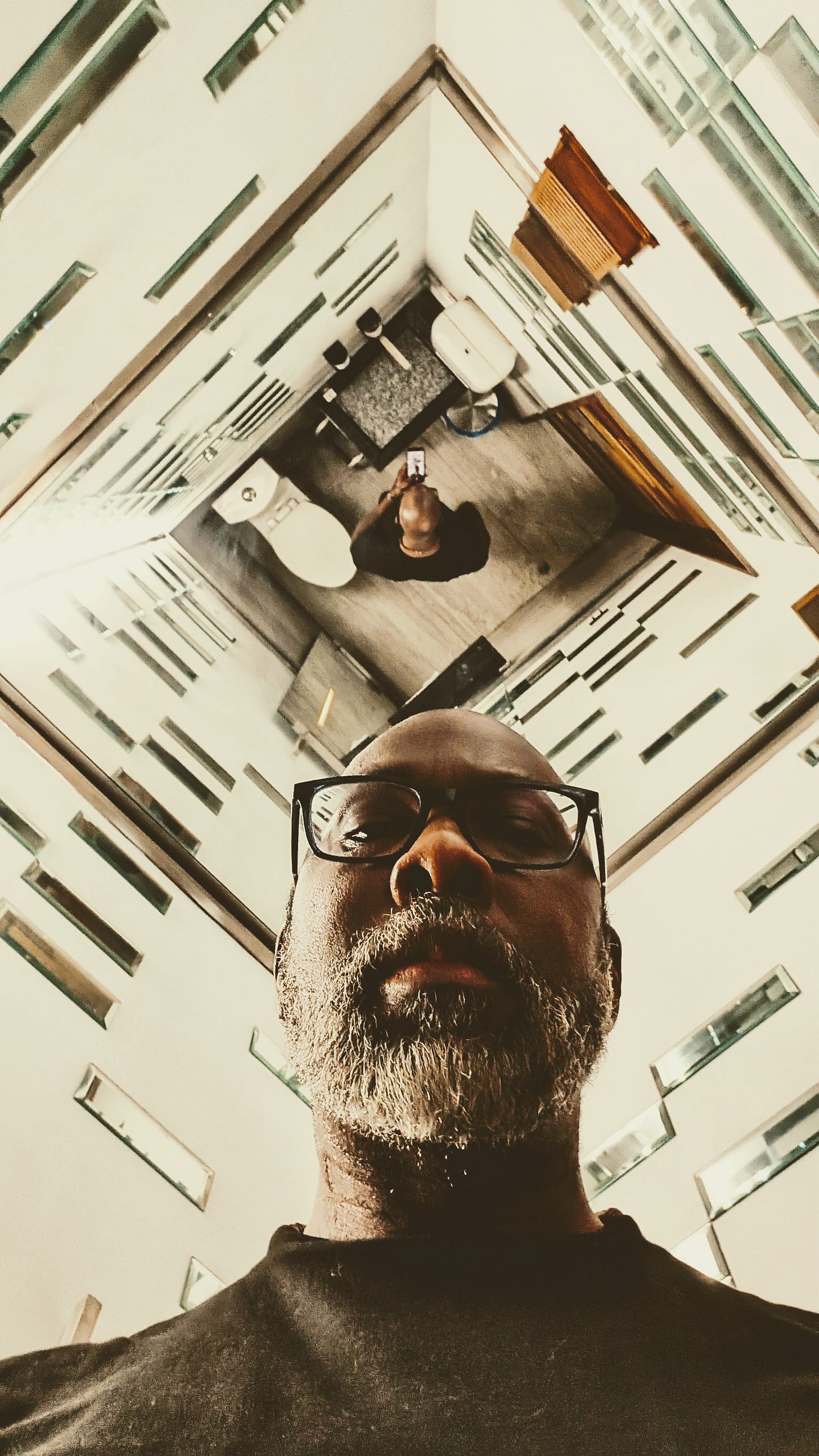 Me in a bathroom in a ceiling mirror