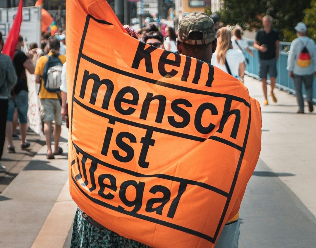 person holding orange and black banner person holding orange and black banner