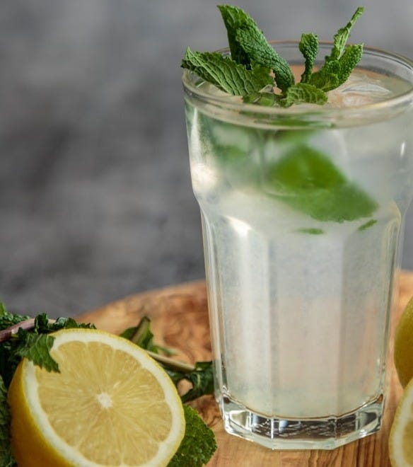 lime juice on drinking glass beside sliced limes