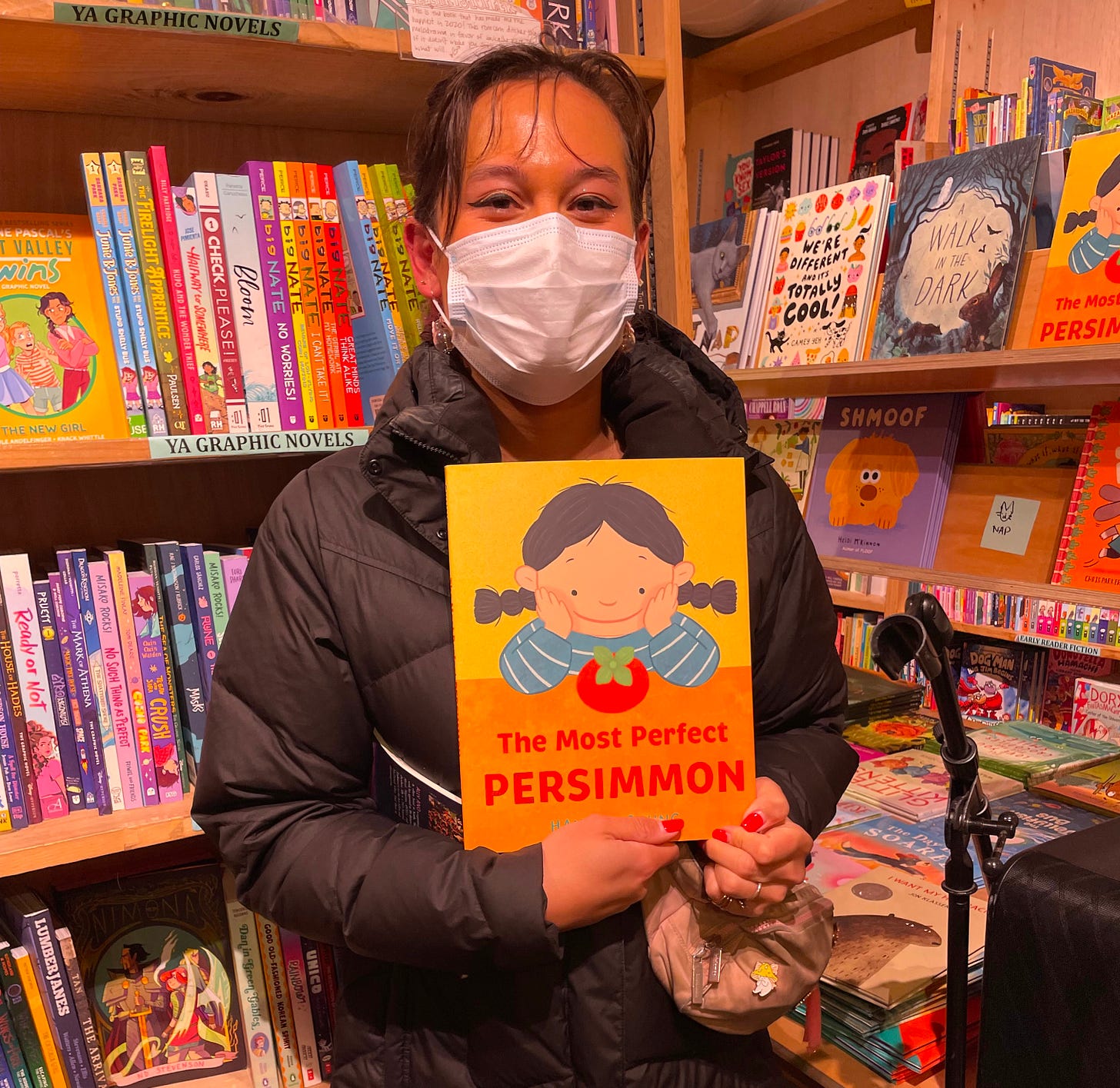 Persimmon holding a book titled "The Most Perfect Persimmon"