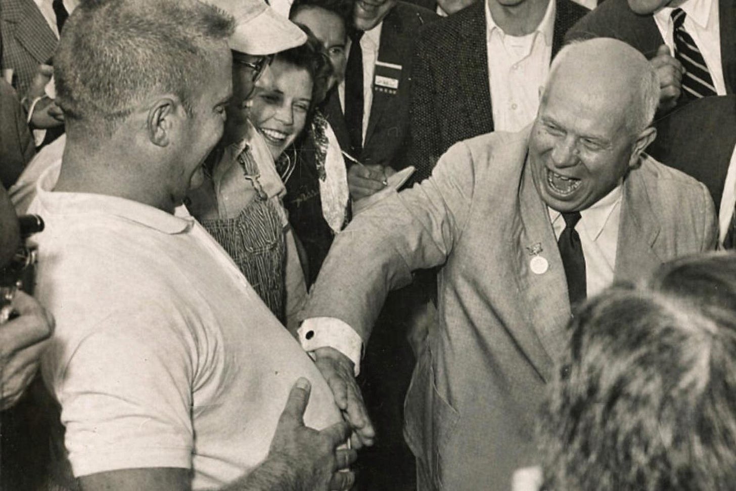 Soviet leader Nikita Khrushchev shares a hearty laugh with an American farmer in Iowa during his memorable 1959 state visit to the United States.