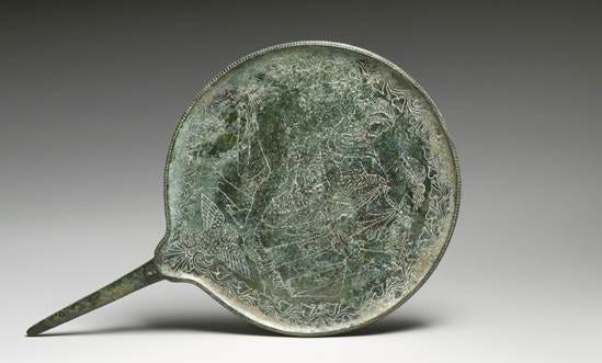 Etruscan bronze mirror engraved with a mythological scene, circa 425 to 400 BCE. Etruscan bronze mirror engraved with a mythological scene, circa 425 to 400 BCE.