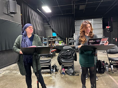 Actors reading a play in a theater.