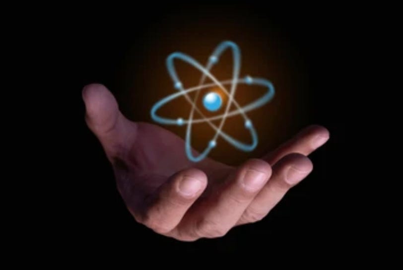 A hand holding a glowing atom

AI-generated content may be incorrect.
