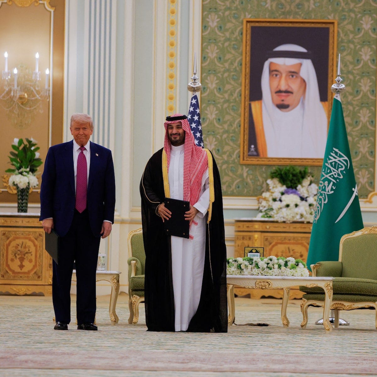 Former U.S. President Donald Trump and Saudi Crown Prince at a high-level economic partnership meeting in a formal setting with national flags