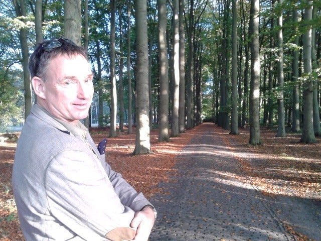 A person standing on a path with trees in the background

AI-generated content may be incorrect.