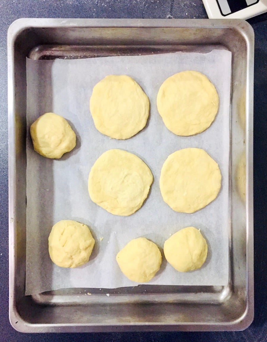 photo of flattened burger bun dough, pre-rise