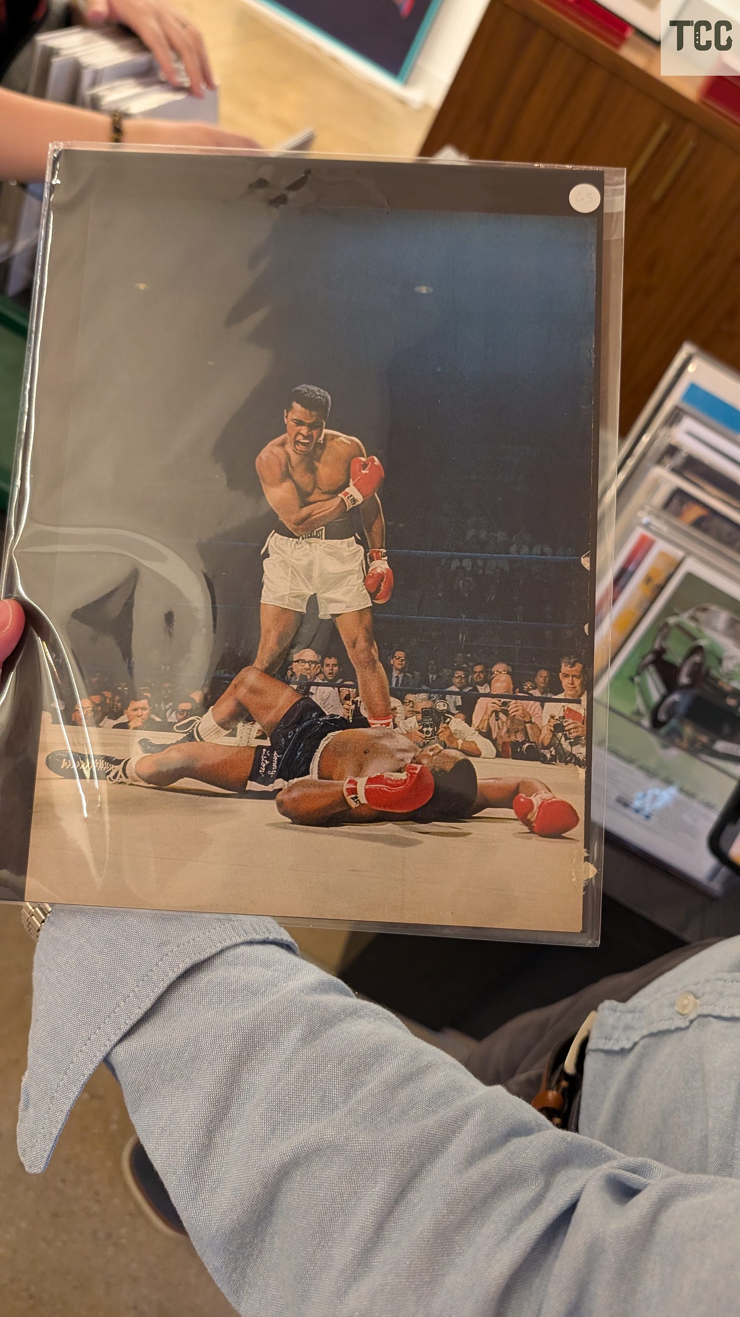 Muhammad Ali, in his prime, standing over his opponent.