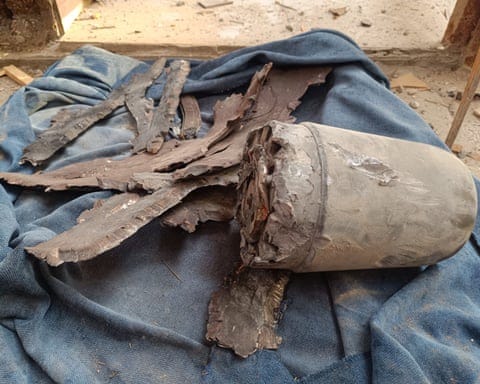 A grey bomb fragment on a blue blanket