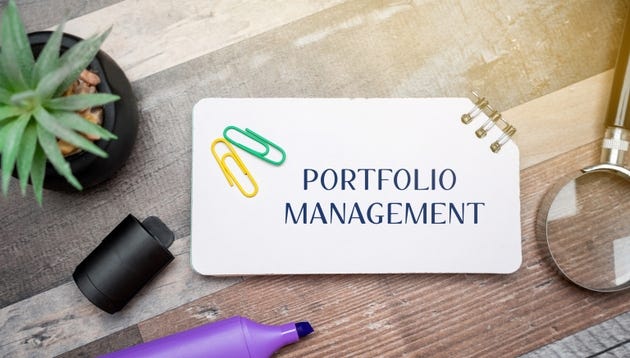 Portfolio management concept. Process of making investment decisions to achieve specific financial goals. business and finance. Inscription on a notepad