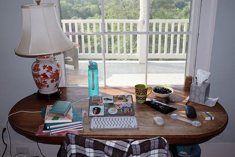 A road sign, a house number, a gate with stone pillars, a parlor with books and piano, a bedroom with writing desk