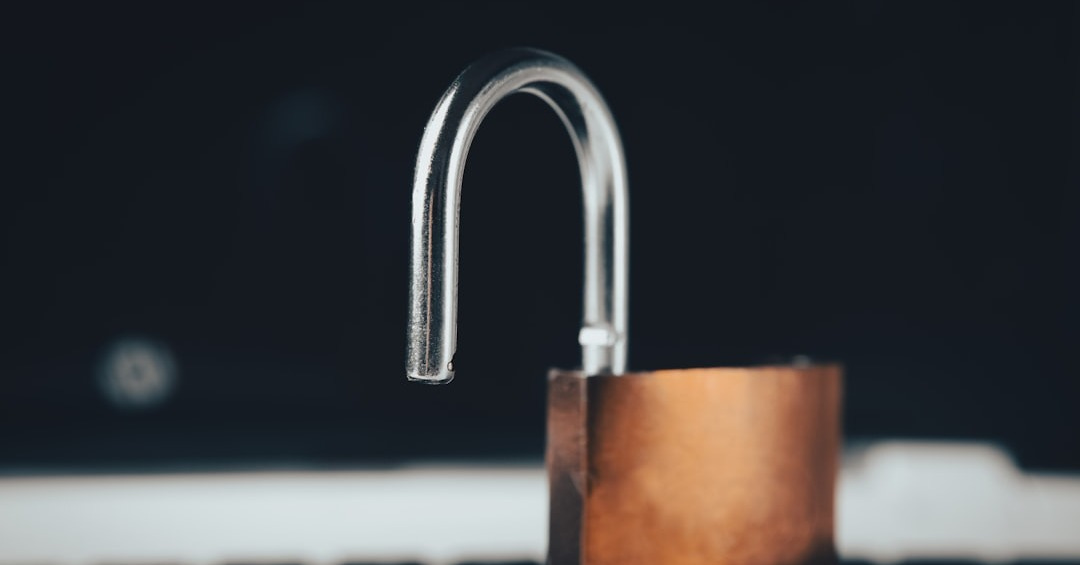 a padlock on top of a laptop computer a padlock on top of a laptop computer