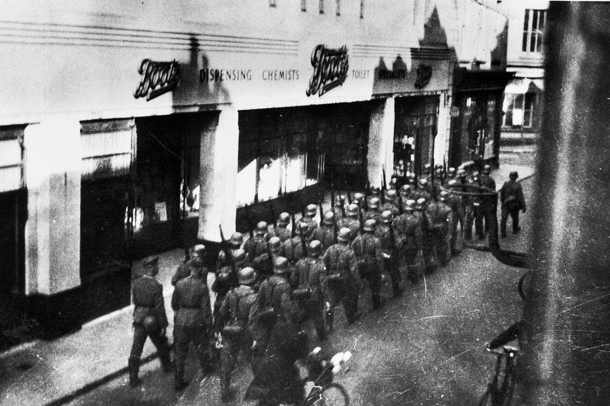 German Soldiers Marching through the streets of one of the British Channel Islands. 1940