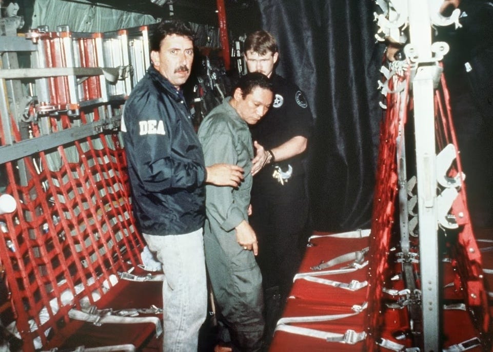 two dea agents holding a man in custody on a military plane two dea agents holding a man in custody on a military plane