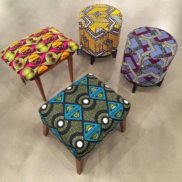 This may contain: four different colored stools with designs on them
