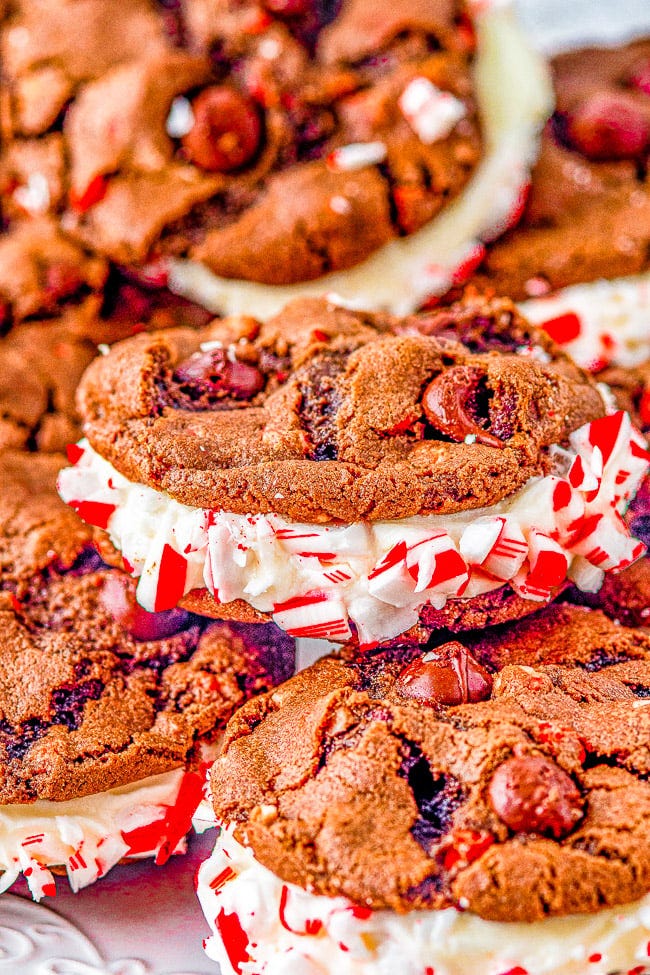 Double Chocolate Peppermint Sandwich Cookies - Rich, decadent, soft and chewy double chocolate cookies are sandwiched together with a tangy cream cheese filling. Rolled in crushed candy canes and drizzled with white chocolate for extra flavor and holiday festiveness! They're the PERFECT Christmas cookie! Double Chocolate Peppermint Sandwich Cookies - Rich, decadent, soft and chewy double chocolate cookies are sandwiched together with a tangy cream cheese filling. Rolled in crushed candy canes and drizzled with white chocolate for extra flavor and holiday festiveness! They're the PERFECT Christmas cookie!