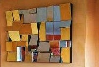 mirror made of many small mirror tiles, oragne wall