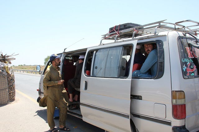 Muhammad Arif, works for the WHO, at a Permanent Transit Point checks a vehicle for unvaccinated children in 108 degree weather. Photo by Devin Thorpe Muhammad Arif, works for the WHO, at a Permanent Transit Point checks a vehicle for unvaccinated children in 108 degree weather. Photo by Devin Thorpe