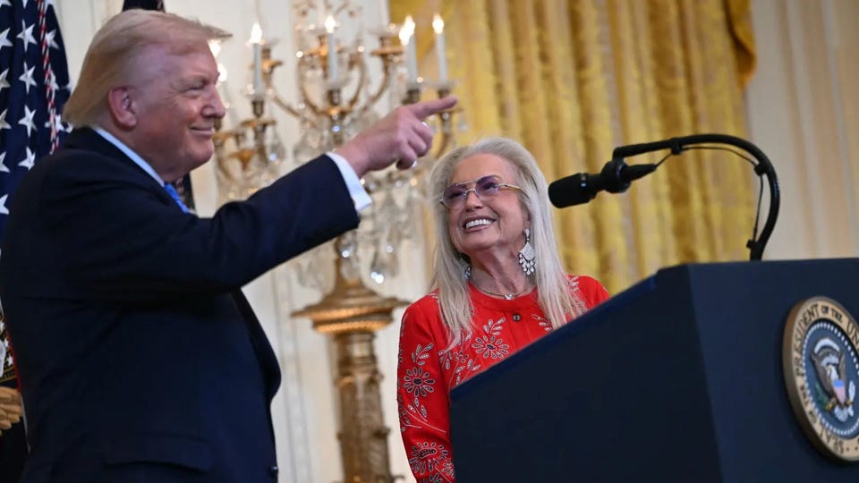 Donald Trump stands at the White House while Miriam Adelson beams beside him, her smile wide and unmistakably triumphant.
