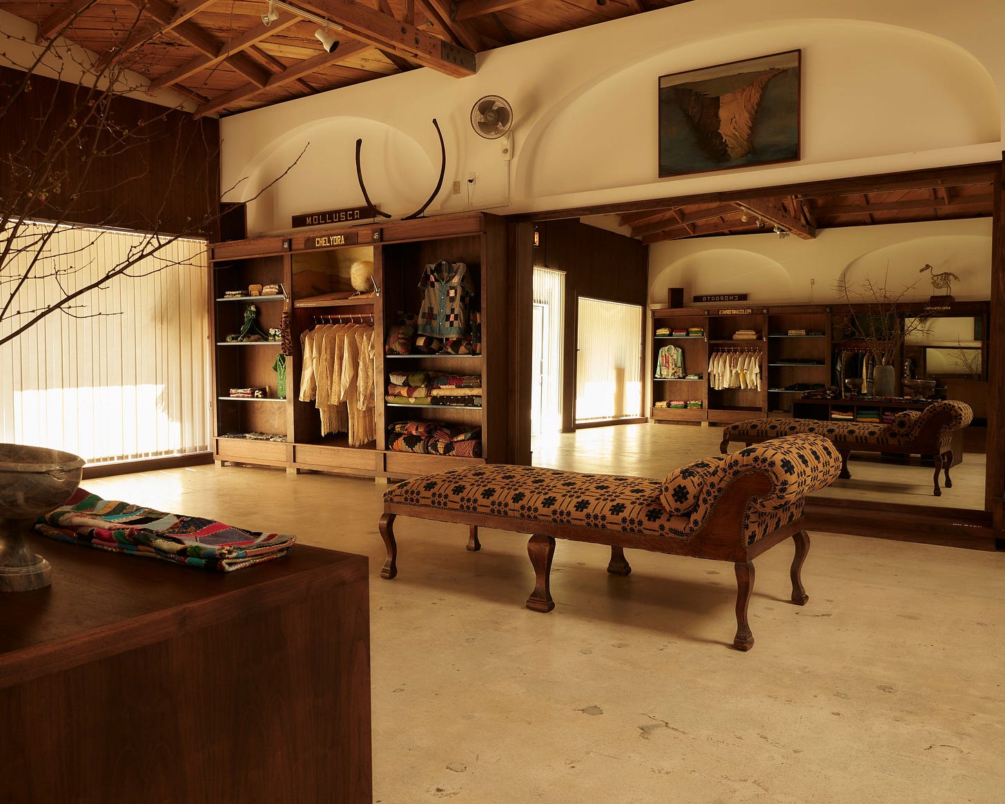 Image may contain Furniture Wood Indoors Flooring Living Room Room Interior Design Floor Hardwood and Closet