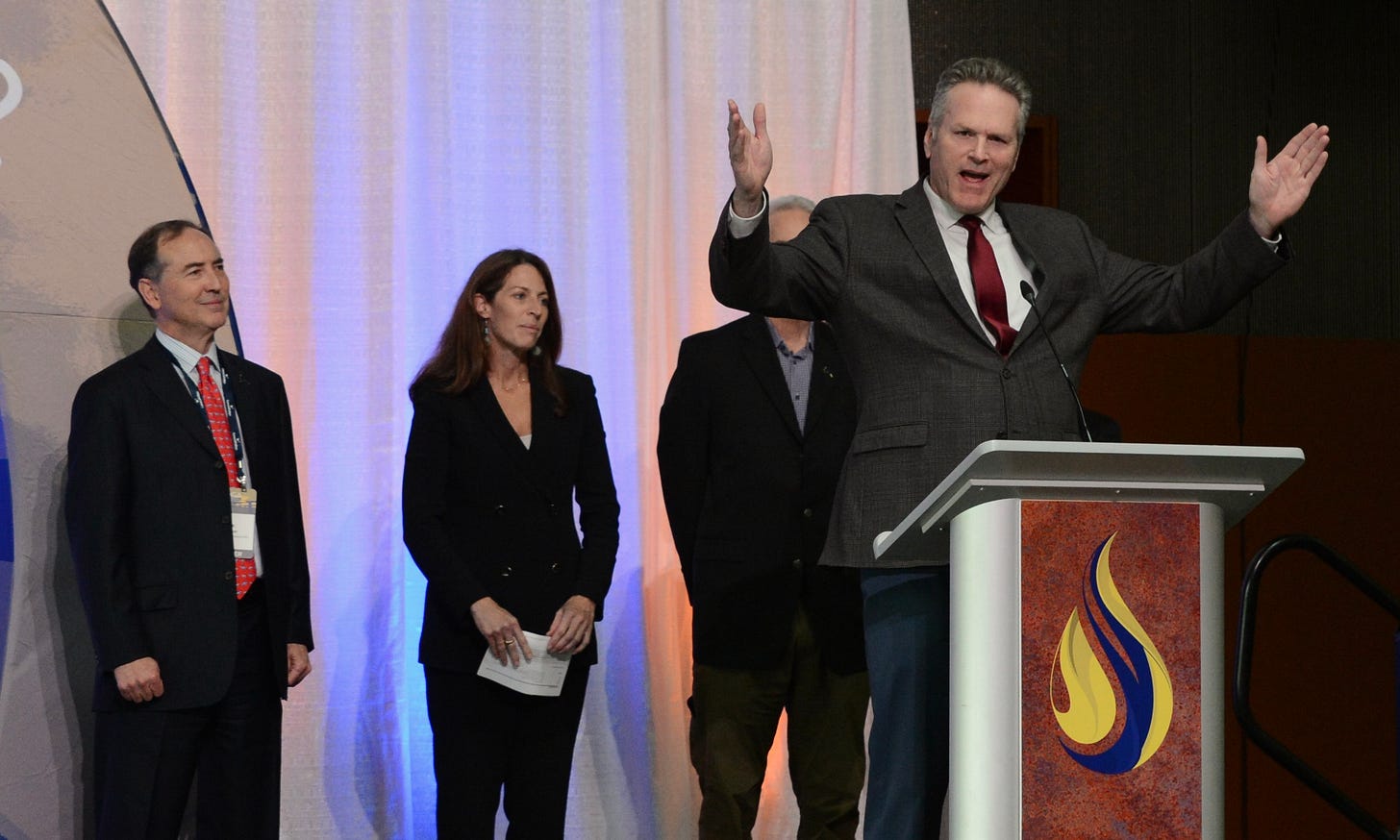 Alaska Gov. Mike Dunleavy talks about his support for the proposed trans-Alaska natural gas pipeline on Thursday, Aug. 28, 2025, during the Alaska Oil and Gas Association conference in Anchorage. At far left is Rex Cannon, co-president of 8 Star LLC, the firm developing the pipeline. (Photo by James Brooks/Alaska Beacon) Alaska Gov. Mike Dunleavy talks about his support for the proposed trans-Alaska natural gas pipeline on Thursday, Aug. 28, 2025, during the Alaska Oil and Gas Association conference in Anchorage. At far left is Rex Cannon, co-president of 8 Star LLC, the firm developing the pipeline. (Photo by James Brooks/Alaska Beacon)