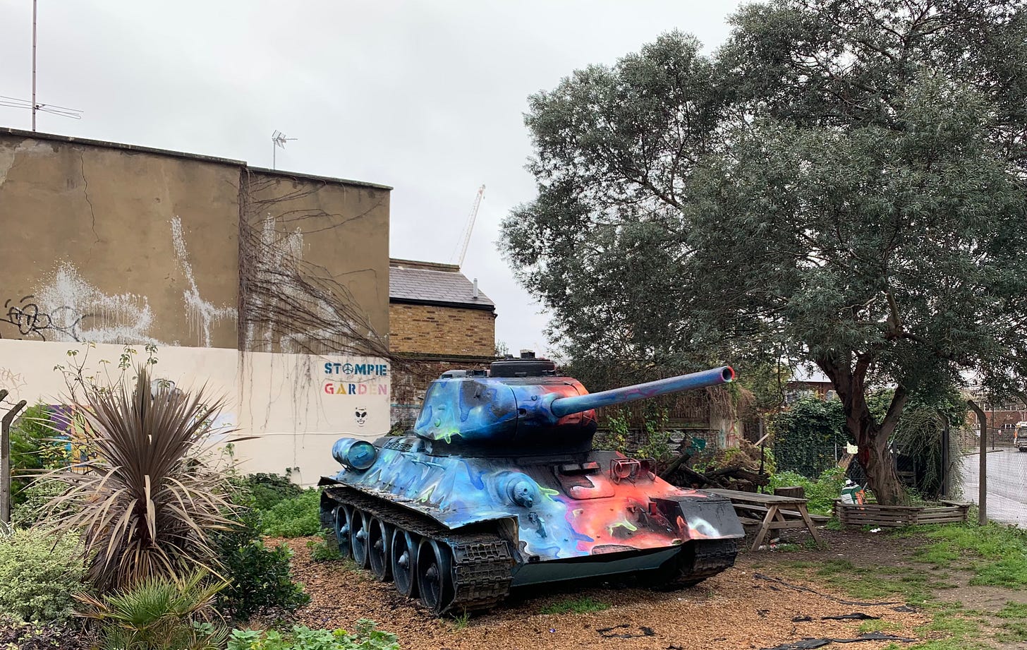 A photo of a tank nicknamed Stompie on Pages Walk in Bermondsey. At the end of a terrace of Victorian era worker's cottages, this site has been empty for decades due to a long running dispute with the local council. Rumour has it that the tank was installed by owner and its gun pointed in the direction of the councils offices (which have since moved). Every so often local artists come along to paint a new mural over the tank.
