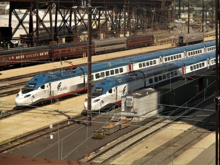two trains are parked next to each other on the train tracks in an ...