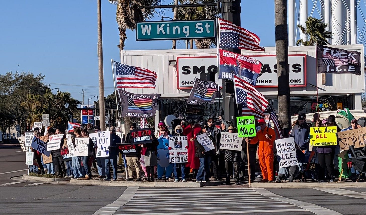 A group of people protesting against ICE in Cocoa, Florida, with signs and American flags. A group of people protesting against ICE in Cocoa, Florida, with signs and American flags.