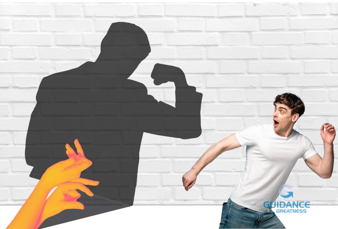 A young man in a white t-shirt and jeans is poised to run away from a white brick wall with a surprised expression, while orange-yellow gradient hands cast a large shadow behind him on the wall. The shadow depicts a muscular figure flexing its bicep, creating a stark contrast between the actual appearance of the unthreatening hands and the powerful silhouette projected on the wall.