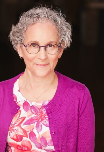 A person wearing glasses and a purple sweater

AI-generated content may be incorrect.