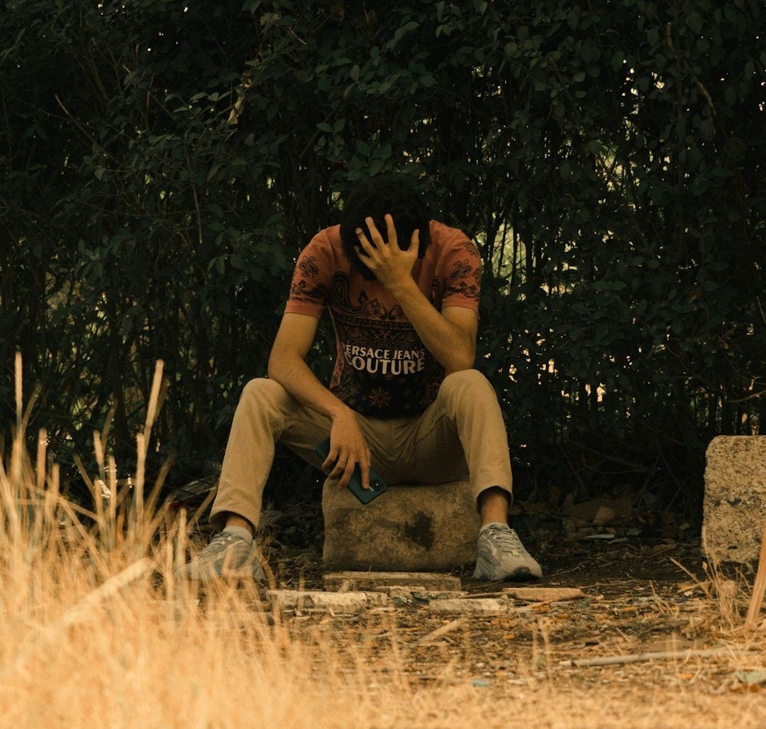 a man sitting on the ground a man sitting on the ground