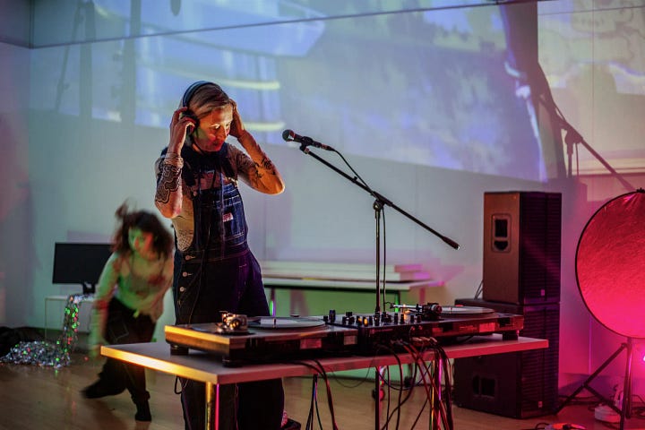 Images of artists working with computers and projectors in an art gallery