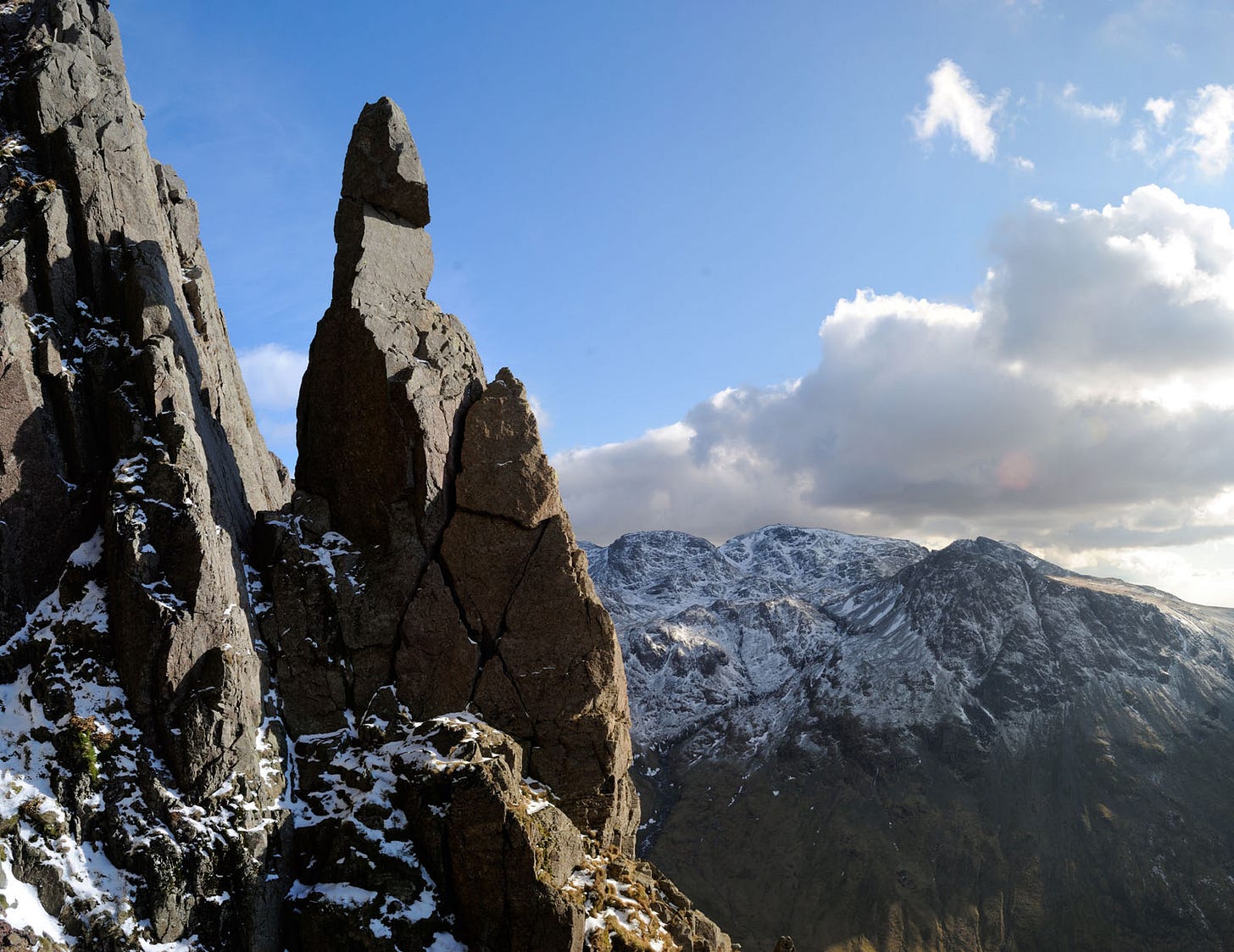 rock pinnacle, snowy hills  behind