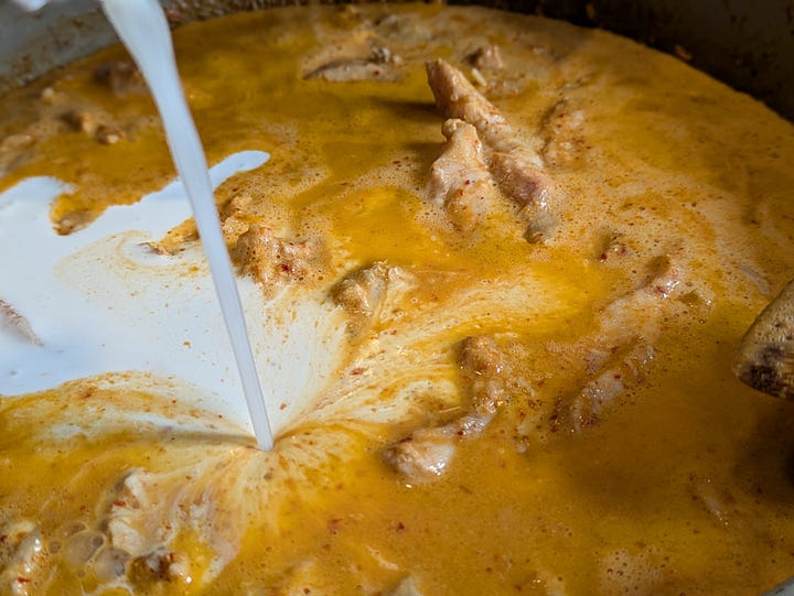 Coconut cream pouring into panang curry base. Panang curry paste just before mixing with coconut cream.