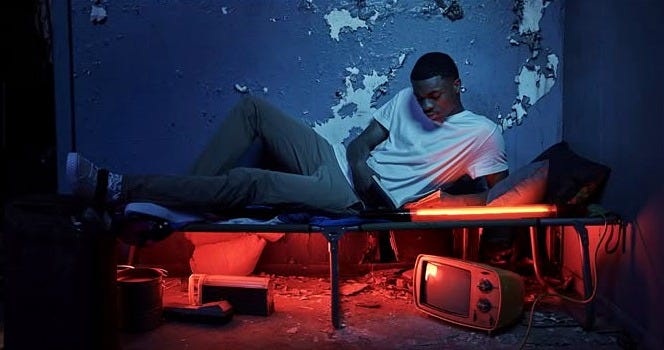 This may contain: a man laying on top of a bed in a room with peeling paint and walls