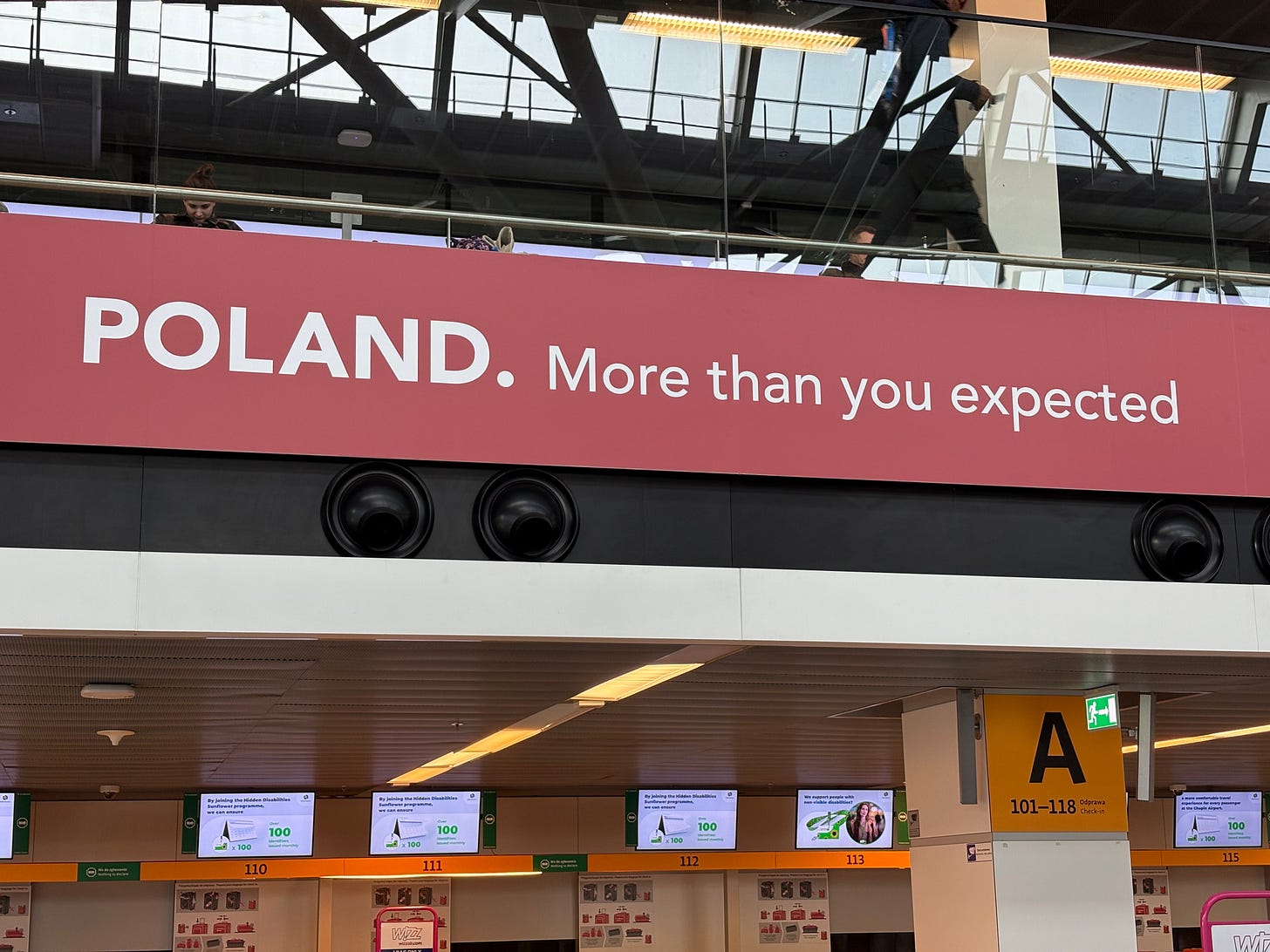Poland’s tourist advertising — shown here at Warsaw airport — acknowledges the country’s reputational deficit. 
