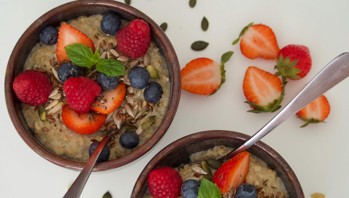 Bowls of porridge topped with seeds and berries