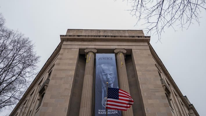 Huge Trump Banner, Campaign Slogan Hangs At Department Of Justice Entrance Huge Trump Banner, Campaign Slogan Hangs At Department Of Justice Entrance