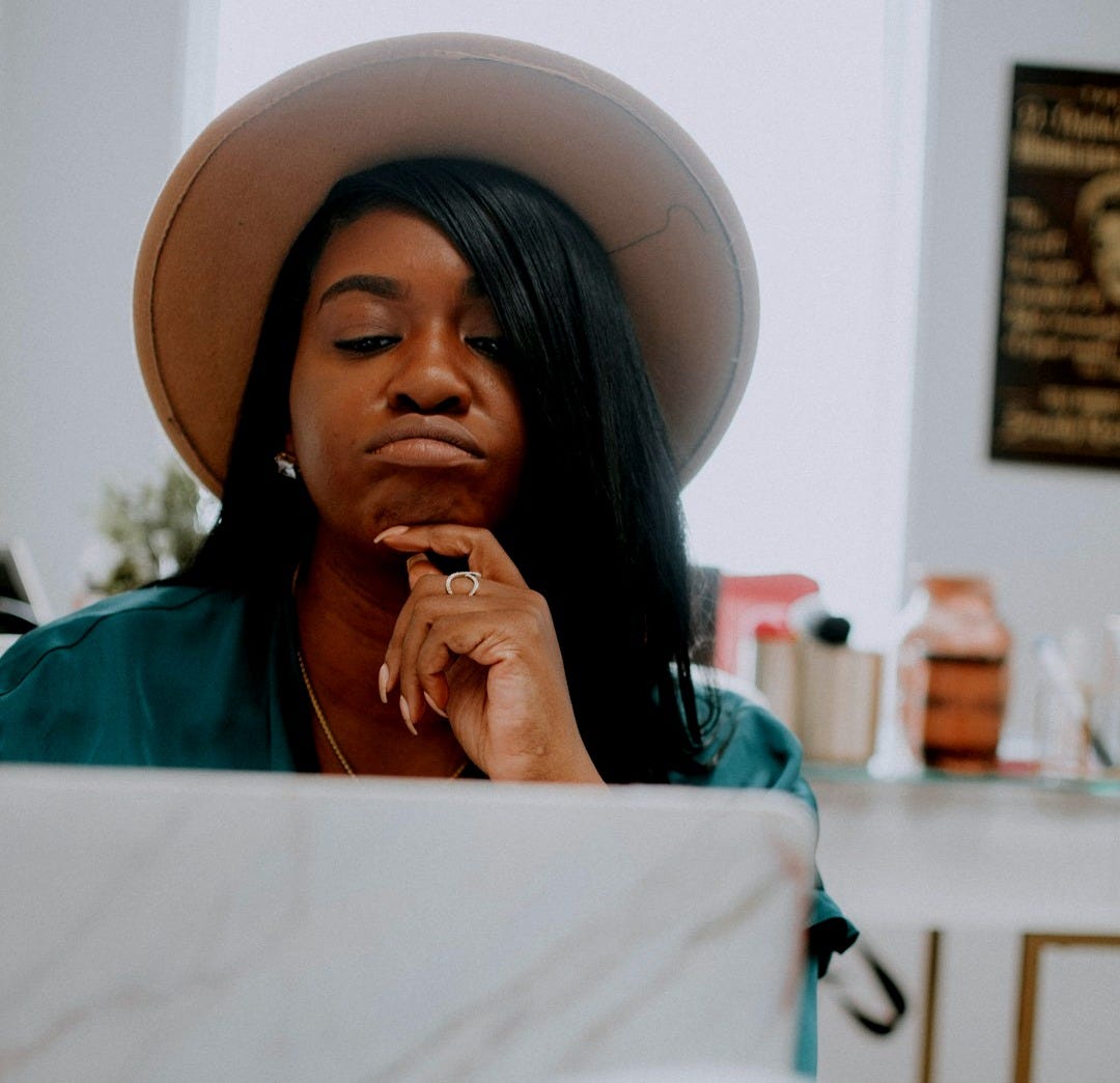 woman in green shirt wearing white hat