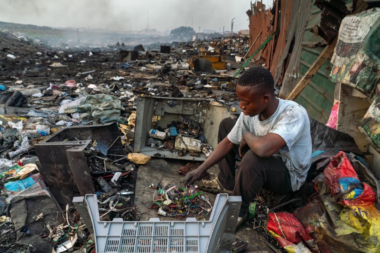Emmanuel Akatire, 20, roams around e-waste processing areas with a sack, sorting through discarded e-waste materials and separating them by material – copper, iron and aluminum – for sale. Muntaka Chasant for Fondation Carmignac