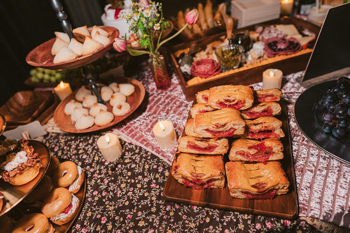 Cakes and treats abundantly displayed on a banquet table.
