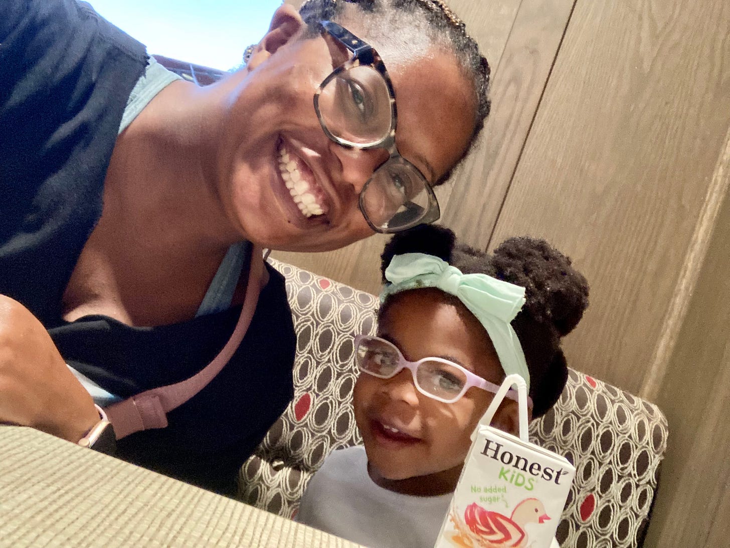Black woman and daughter smiling