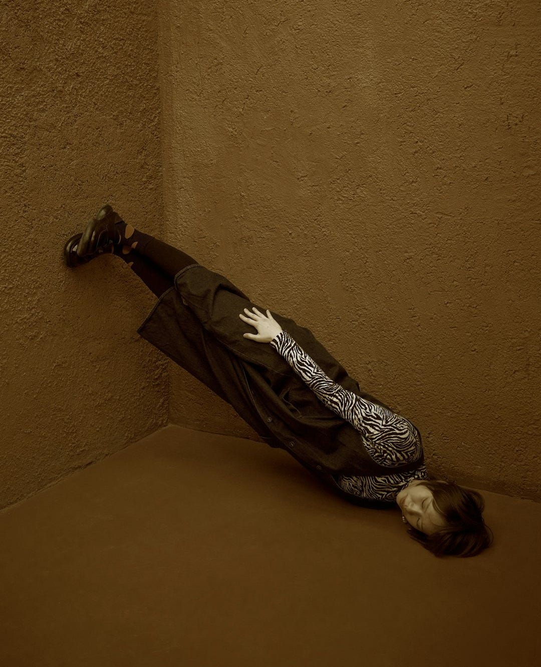 A person laying on the ground in a room