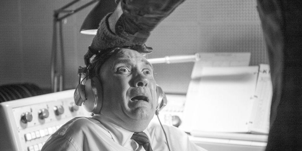 A man in a radio station looking terrified.